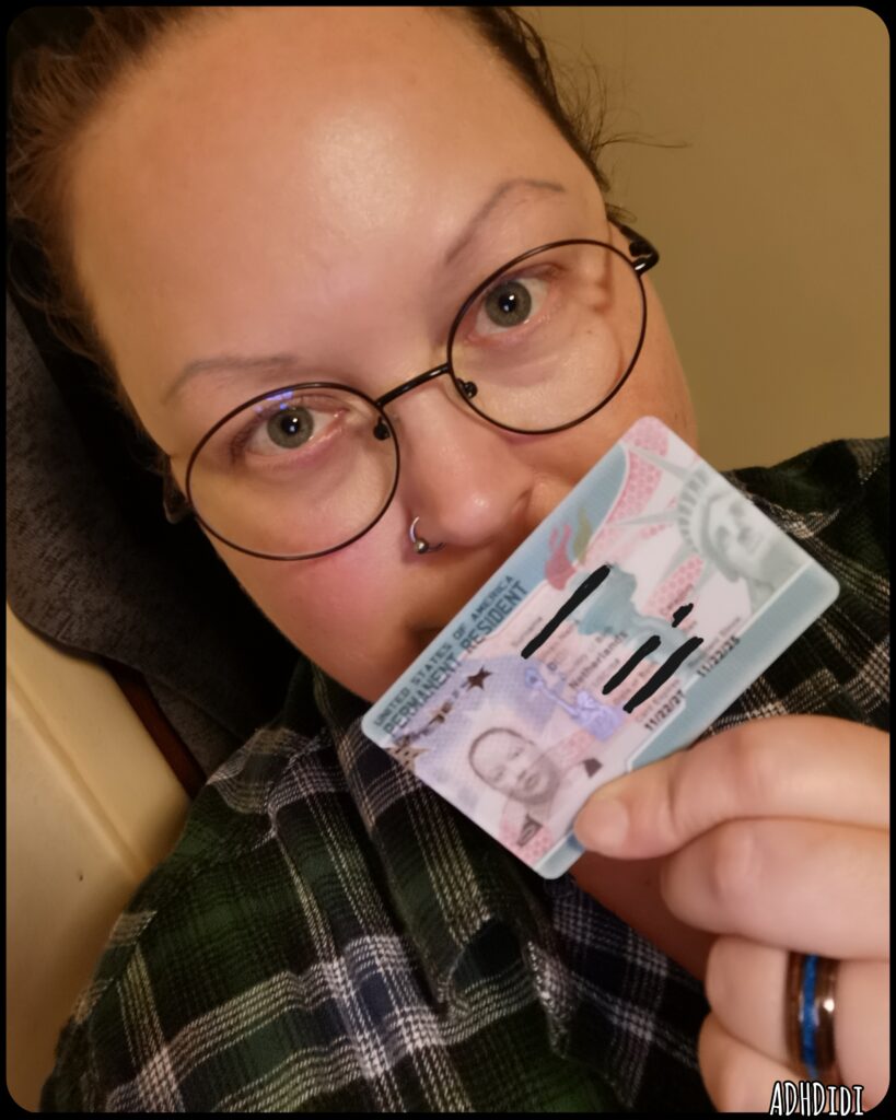 Selfie of very happy Didi holding his Green Card for the first time. Don't worry, important info has been blacked out.